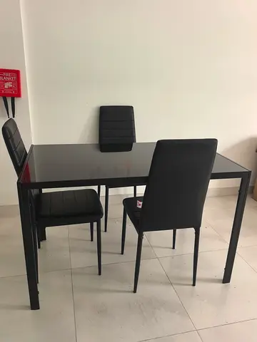 Black Dining table with glass top for sale AED 100 only with 3 free chairs