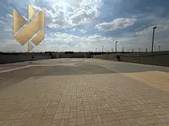 A walled plot of land with interlocking pavers, suitable for manufacturing and any commercial activi