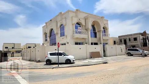 Villa for sale in Ajman, Al Zahia area. It features 5 master bedrooms, a majlis (formal sitting room), a living room, and a maid's room. Freehold owne