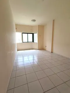 For rent in Al Nahda: 2BR with separate hall, balcony, 2 baths, central AC, prime location near serv