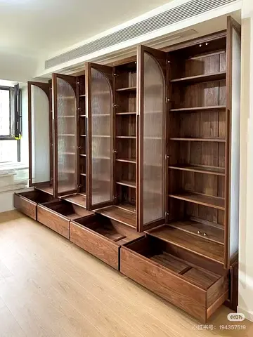 Built-in solid wood storage cabinets with fluted glass doors and drawers