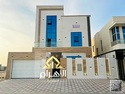 Luxury villa for sale in Al Bahia area, featuring two floors and a rooftop terrace. Modern design, spacious living areas, reception halls, and compreh