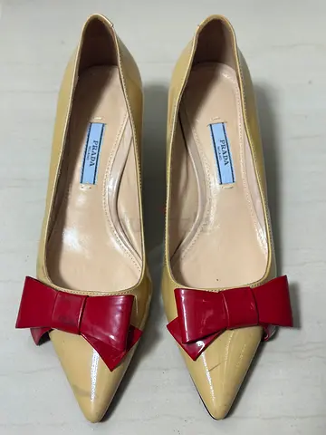 Preloved Prada beige patent pumps with red bow
