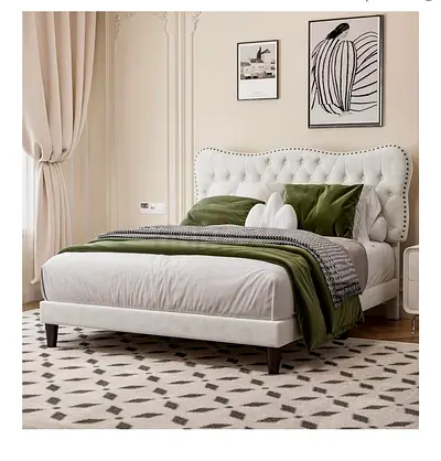 White tufted upholstered bed frame with padded headboard