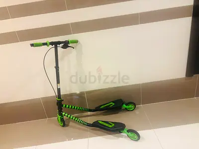 Green dual-deck kick scooter, used - good condition
