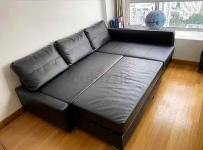 Selling  black L-shaped leather sofa bed — converts to bed, good condition