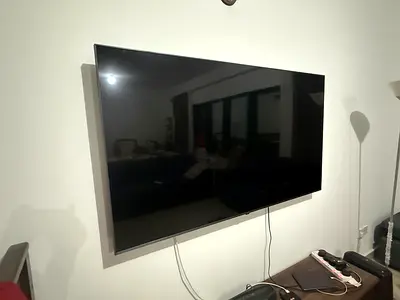 Wall-mounted flat screen LG UHD LED TV - good 3 year old