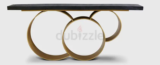 Console table with black stone top and gold circular ring base