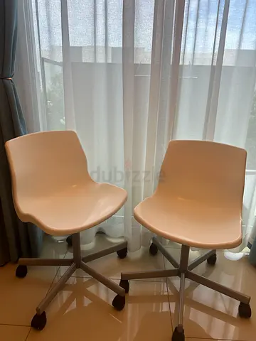 2 swivel white chairs