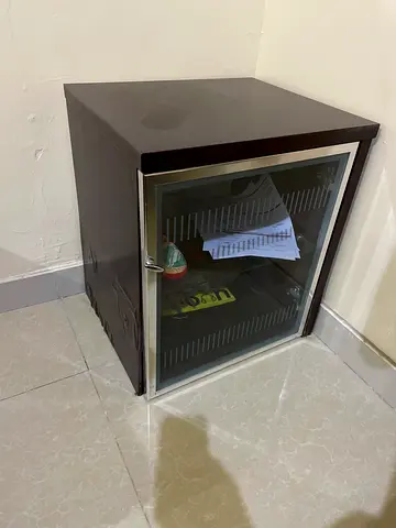 Dark wood bedside cabinet with glass door - damaged condition