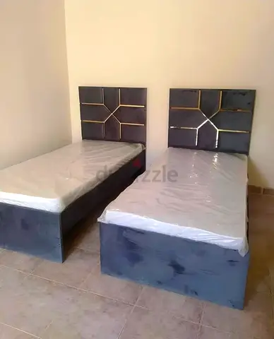 Brand New Two grey single upholstered beds with mattresses