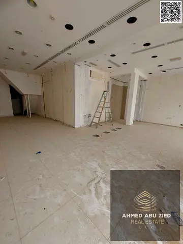 Annual rent: large shop with mezzanine (900 sq ft), private bathroom, ready finishes, strategic prime location, suits all businesses.