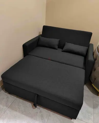 Compact dark grey pull-out 2-seater sofa bed