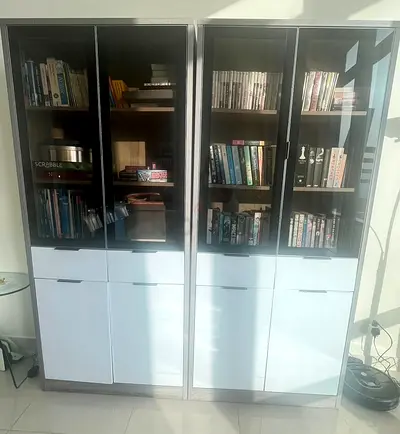 Set of 2 tall glass-front living room cabinets with beautiful internal cladding from Home Centre.