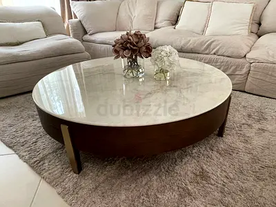 Round marble-top coffee table with wooden base