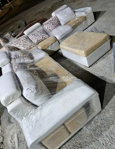 L-shaped 6-seater sofa set with ottoman — wrapped for moving