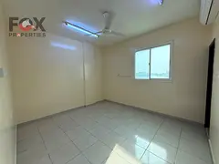 2-bedroom apartment in Al Rawda 1 with 2 baths, balcony, split AC, separate hall, prime location nea