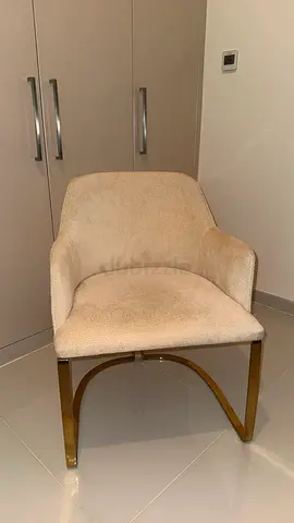 Luxurious Beige upholstered accent chair with gold metal base