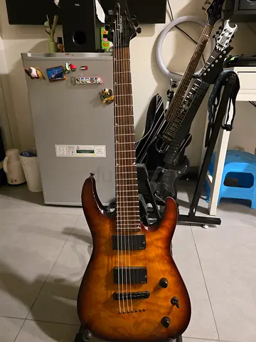 My 7-string electric guitar — quilted amber top, good condition