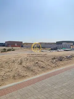 For sale: land in the Al-Sajja Industrial Area, Sharjah. Area: 68,000 sq. ft., 36-meter main street.