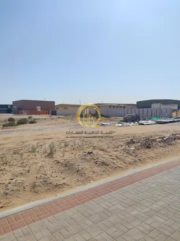 For sale: land in the Al-Sajja Industrial Area, Sharjah. Area: 68,000 sq. ft., 36-meter main street.