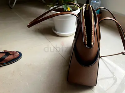 Brown structured womens shoulder handbag with gold zipper - never used