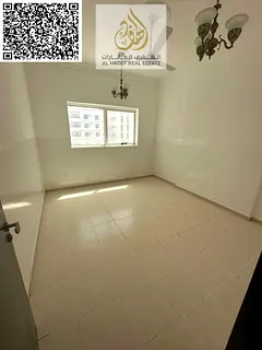For annual rent in Ajman - Directly on Al Ittihad Street - Two-bedroom apartment with a living room