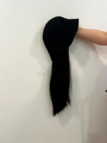 Black knit beanie with long attached ponytail