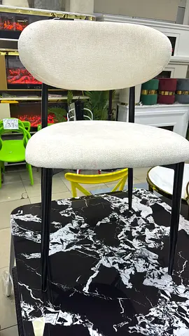 Beige color dining chair with black metal legs