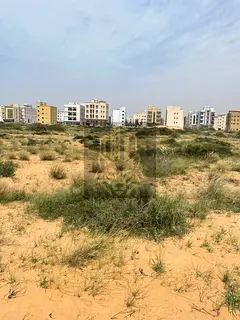 Residential commercial land for sale in a prime location in Al Aliya at an incredible price