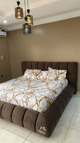 Plush brown upholstered bed frame with padded headboard