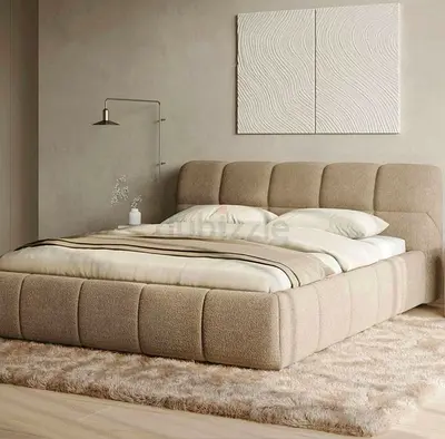 Beige upholstered platform bed with padded headboard