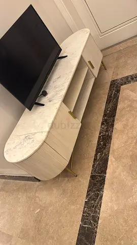 Oval marble-top TV cabinet with storage and brass legs
