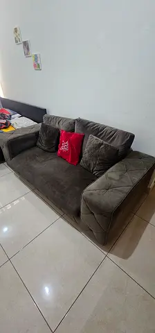 Three-seater grey fabric sofa in good used condition with coffee table