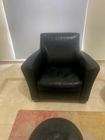 My black genuine leather armchairs with matching ottoman - very good condition