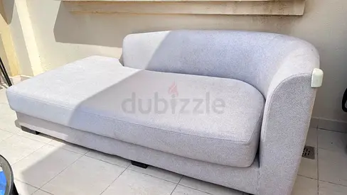 Light grey curved lounge sofa – used, good condition