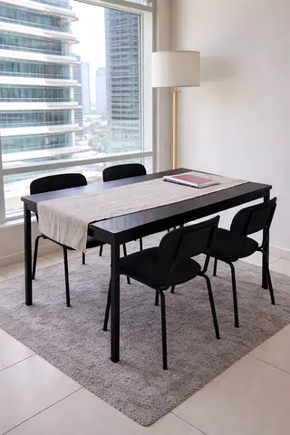 Black modern dining set (table + 4 chairs) — used, good condition with rug