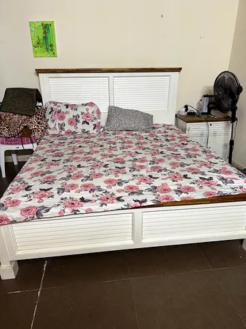 White Wooden Bed Frame with Floral Bedding