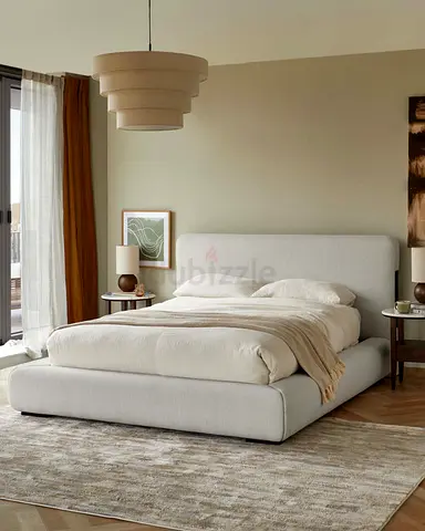 My beige upholstered platform bed with padded headboard