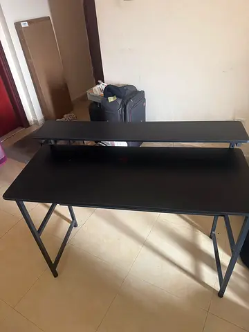 Black compact computer desk with raised monitor shelf