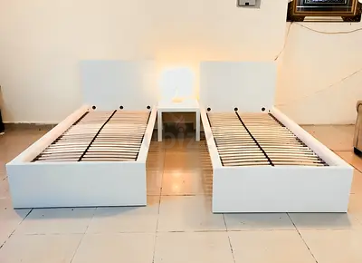 Two white single bed frames with slatted bases (set of 2)