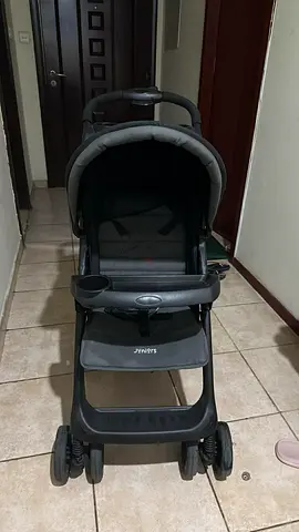 Grey standard baby stroller with child tray and storage