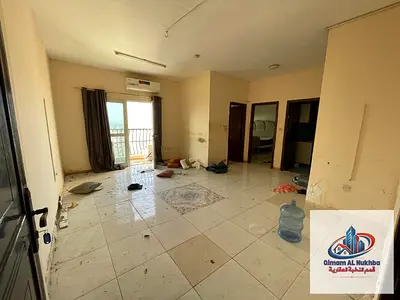 The most beautiful and largest one-bedroom apartment with a living room in Al Qulaya’a, featuring a balcony with a sea view .