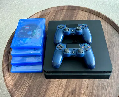 Sony PS4 Slim with 2 DualShock 4 Controllers and 4 Games