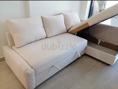 Light beige storage sofa bed with pull-out drawer and cushions