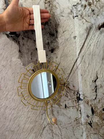 gold-colored, sunburst-style over-the-door hanging mirror  20 AED 💰