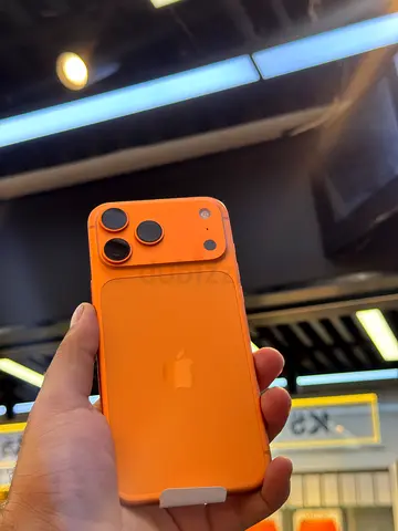 Apple iPhone with orange case — good condition