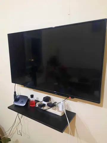 42-50 inch LED TV with wall shelf and power strip (used)
