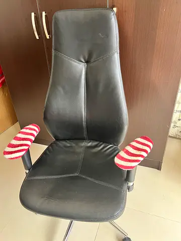 Black faux-leather swivel office chair with armrests — used, good condition