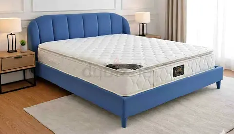 Blue upholstered bed frame with mattress — good condition